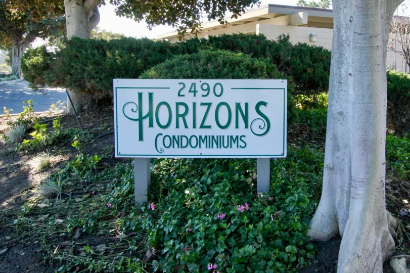 A name board of 2490 Horizons condominiums with a beautiful view.
