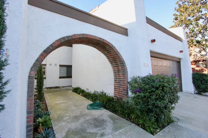 The entrance of a big house and one door closed and also small plants in front of the entrance at the morning time.
