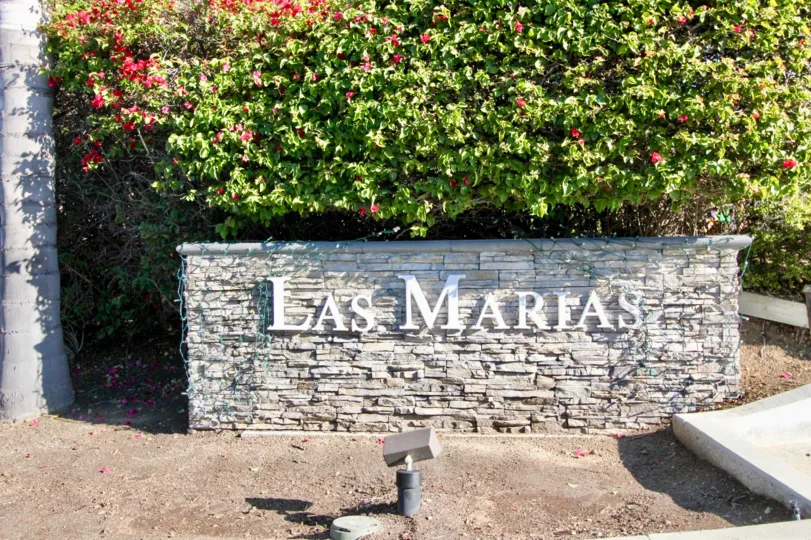 Outer view of building with rock made wall and colourful flowers in Las Maarias.