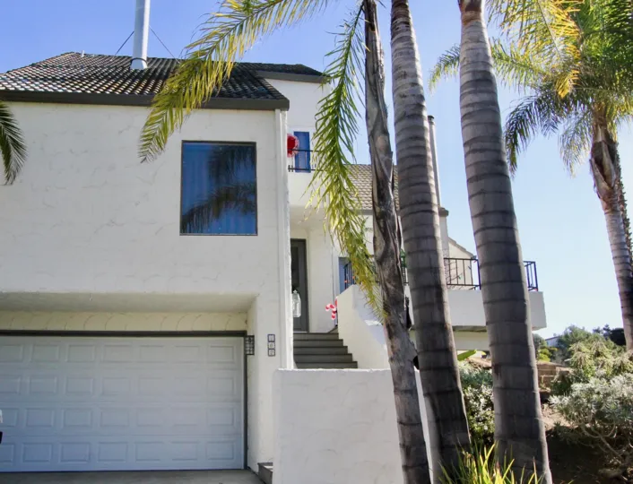 A red and white striped candy cane decoration sits on a porch at Las Marias condos