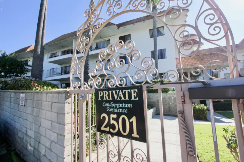 A very ornate pinkish gate in the Ocean Fairways community.