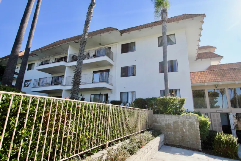 Three stair building with tall palm trees and nice balconies in Ocean Fairways.