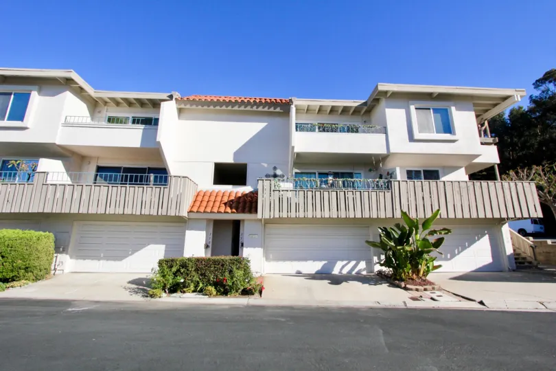 THE BUNGALOW IN THE OCEAN HILLS WITH THE ROAD, BALCONIS, TREES, PLANTS