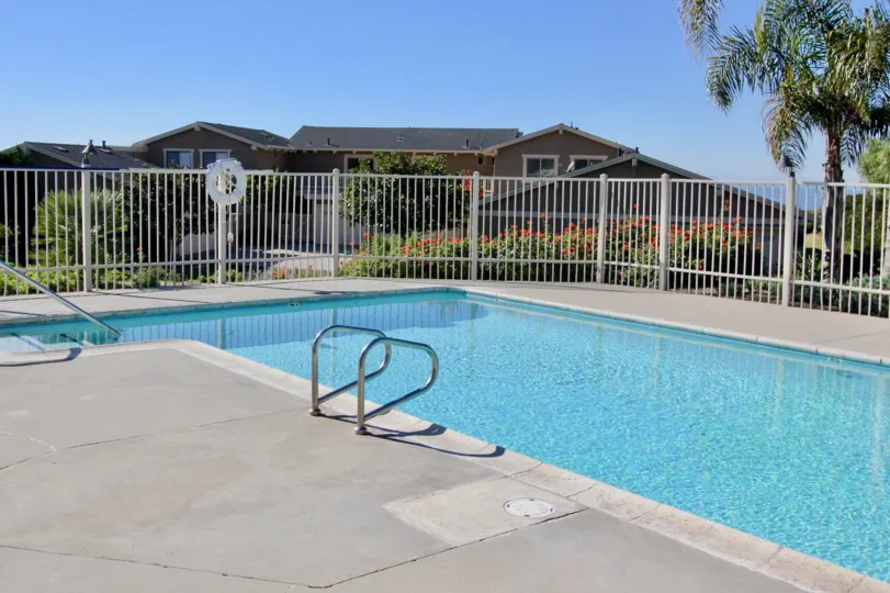 Swimming pool on a sunny day outside a large house in San Clemente