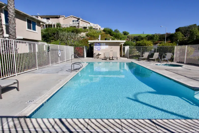 A public pool with white fence in the President Heights I community.