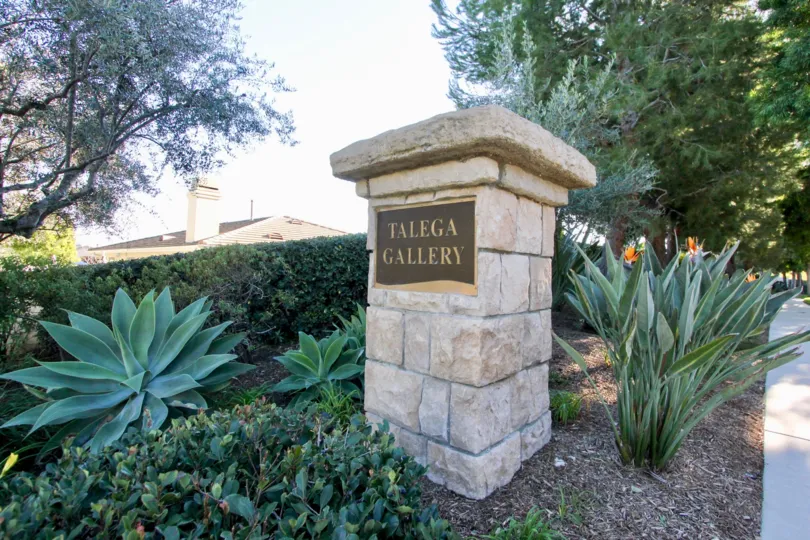 "Talega Gallery" is written on a placard on a brick pillar at Seagarden