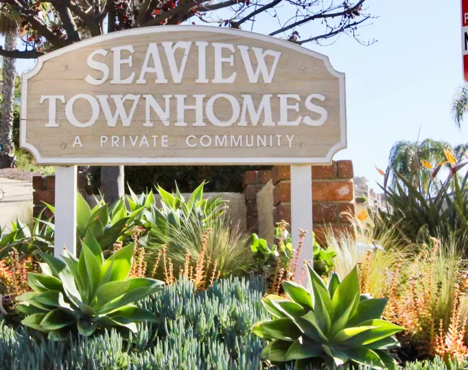Variety plants with name board of Seaview Townhomes.