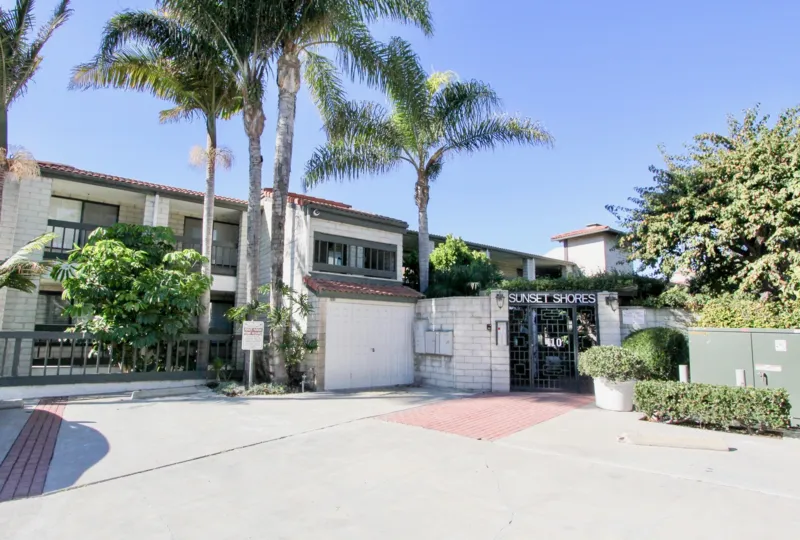 A driveway with a labeled gate in the Sunset Shores community.