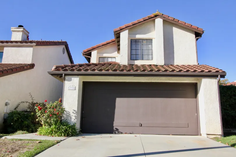 Half of a brown garage door sits in a shadow at Foster Ranch