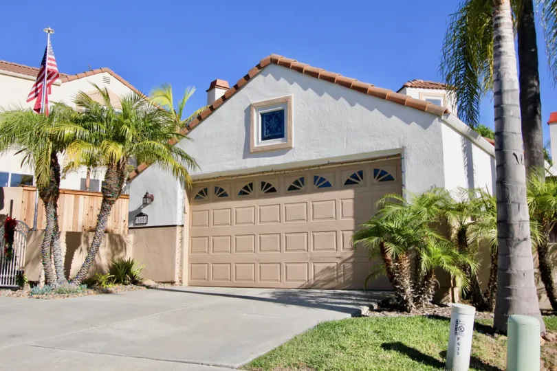 A large garage of a large house with a cream door