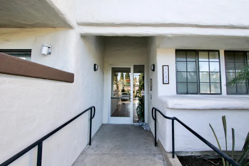 Vista Oceana, San Clemente, CA, An ADA accessible ramp down a white hall at address 3830