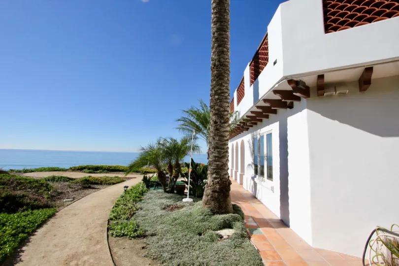 THE SEA IN THE VISTA PACIFICA VILLAS WITH THE TREES, PATHWAY, PLANTS