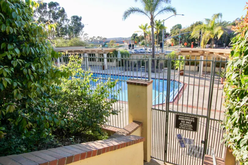 Fence and poolside at Cancun Racquet Club in San Juan Capistrano, CA