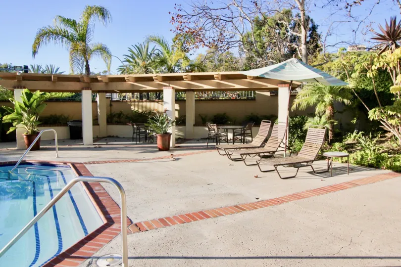 Chairs and a pool at Cancun Racquet Club at San Juan Capistrano, CA