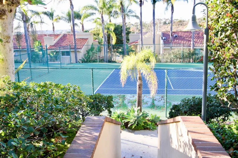 Trees and a tennis court at Cancun Racquet Club in San Juan Capistrano, CA