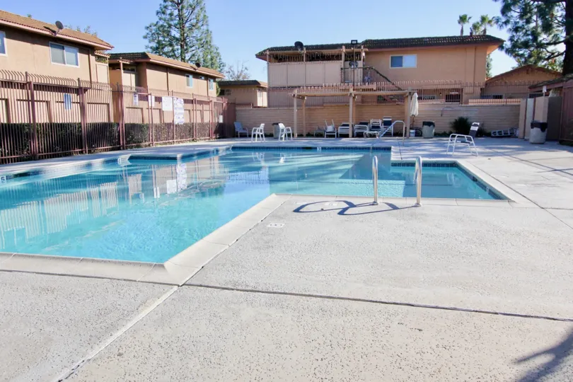 Spacious light brown villa with 6-bay garage and open court in Capistrano Villas.
