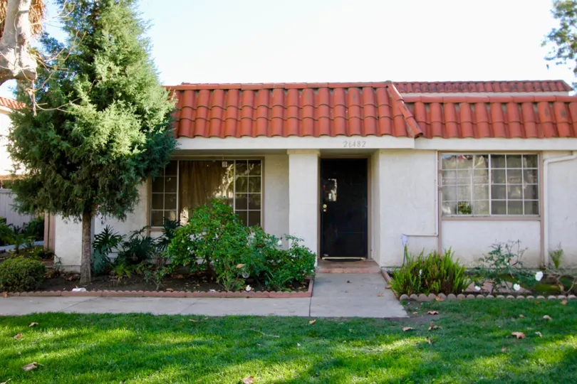 A home with white walls and red roof in Capistrano Villas community in San Juan Capistrano, California.