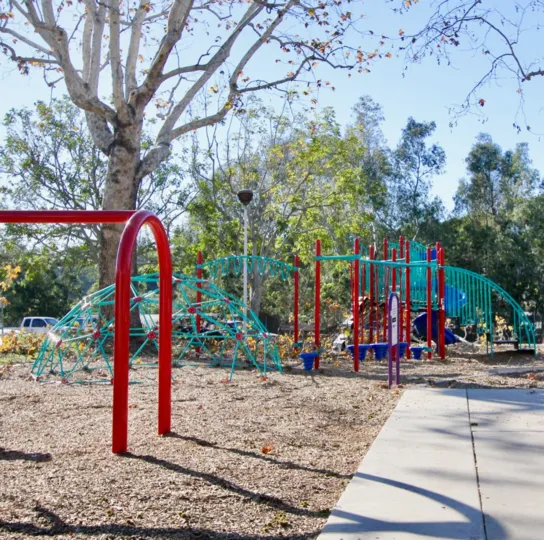 A sunny day in the Capistrano Villas where you will find a childrens playground, equipped with a jungle gym