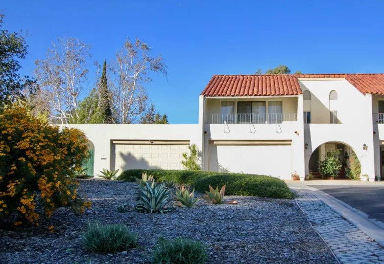 THE FLAT IN THE CASITAS CAPISTRANO WITH THE PLANTS, ROAD, TREES
