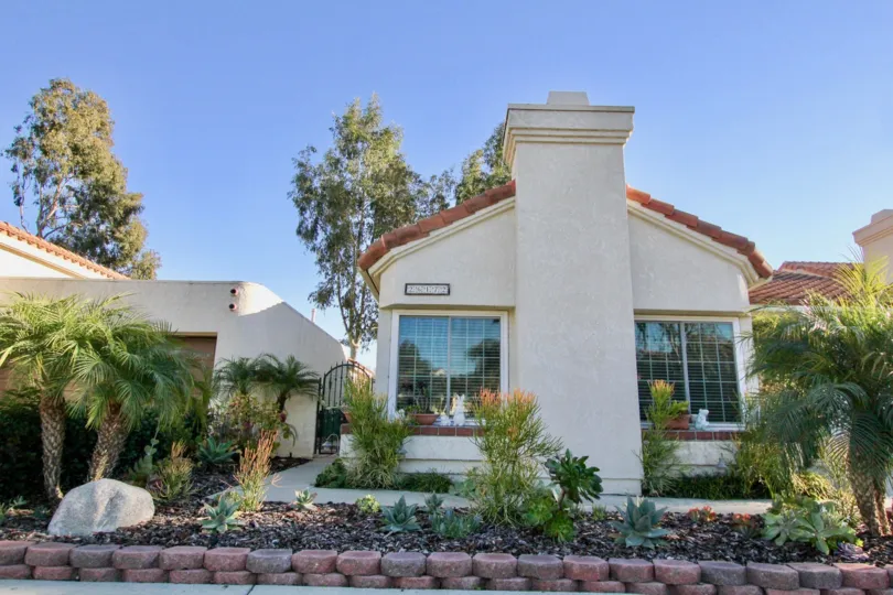 A white home with red roof in the sunny Casitas Del Rio community in San Juan Capistrano, California.
