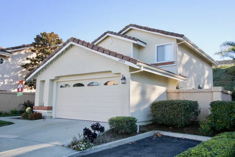 A white home with a garage at Loma Vista community in San Juan Capistrano, california.