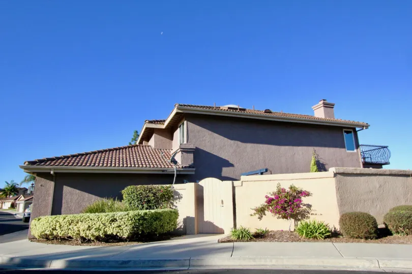 A street view of a sunny day in San Juan Capistrano with residential housing and landscaping