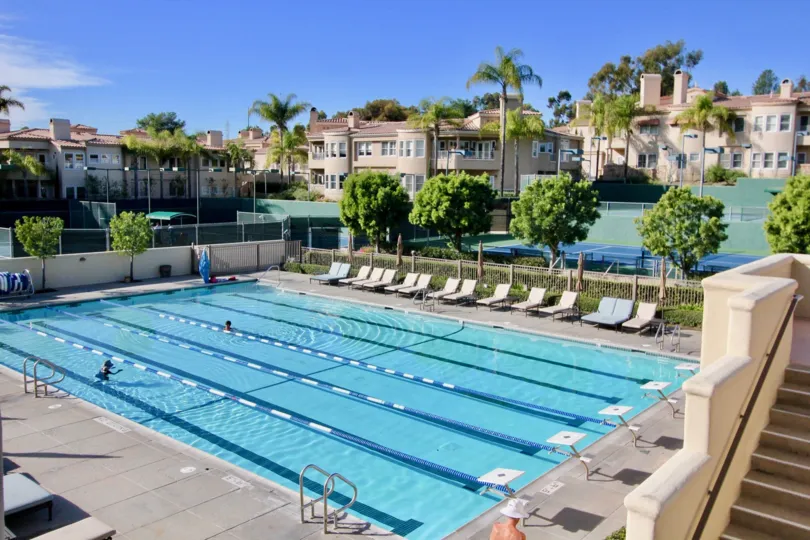 A very large pool with chairs and diving boards at Marbella Golf Villas community in San Juan Capistrano, California.