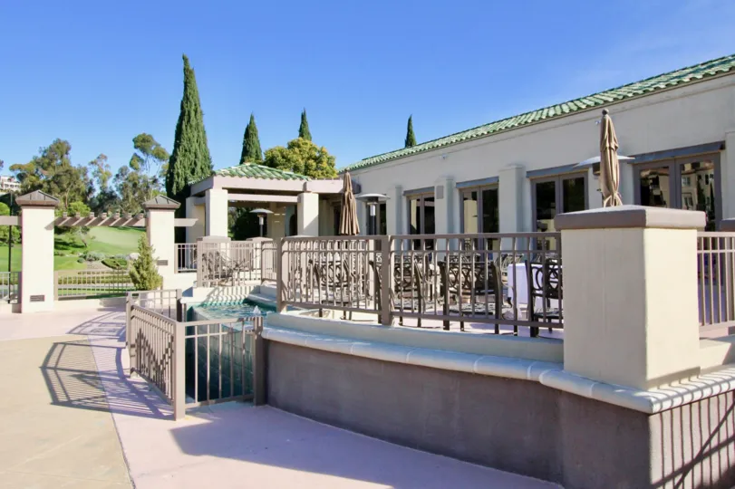 A sunny day in the area of Marbella Golf Villas, outside, condos, table, chairs, fence