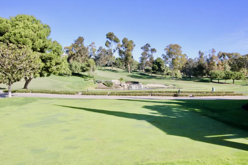 A sidewalk flows through the golf course at the Marbella Golf Villas
