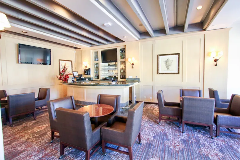 There are some chairs and table inside a house in the Marbella Golf Villas.