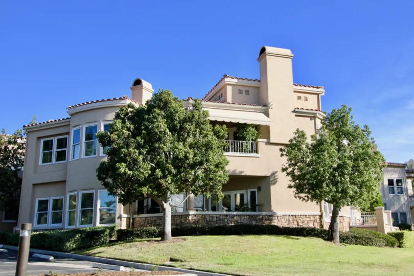 An ornate and decorative condo building sits on a corner at the Marbella Golf Villas