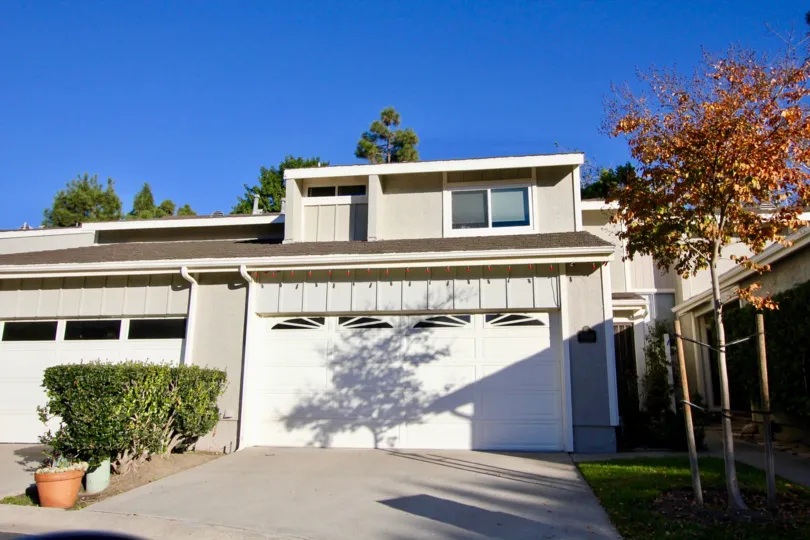 A pale grey home with a garage in Mariners Village community in San Juan Capistrano, California.