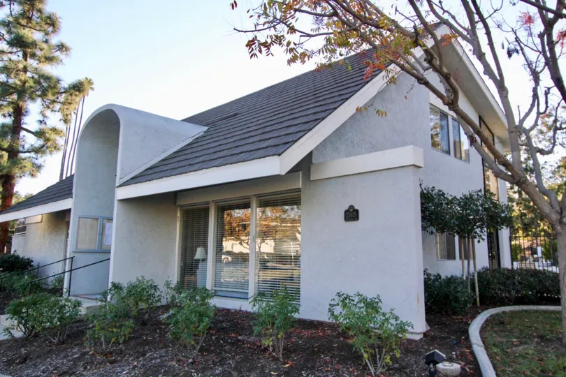 An arched doorway sits on a gray building at the Mariners Village condos