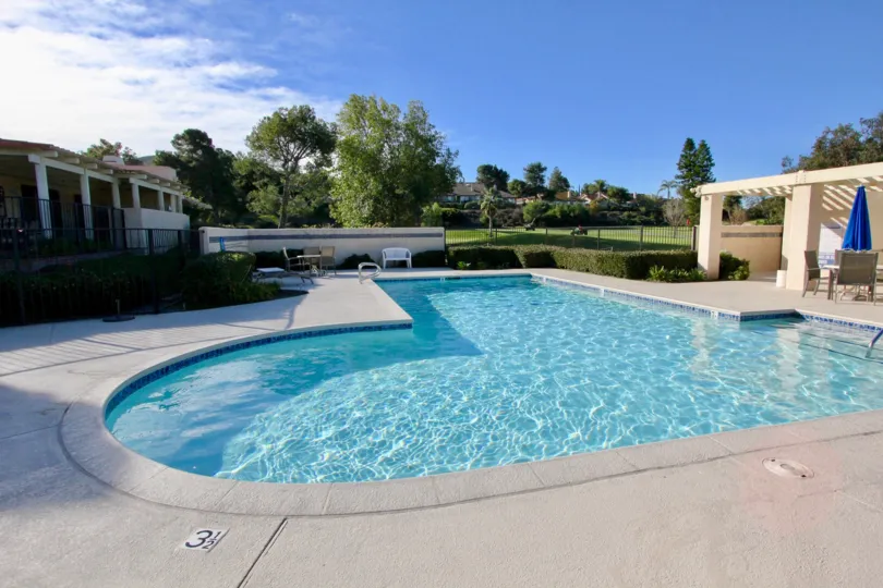 mesa verde community pool with sun deck and lounge chairs to relax