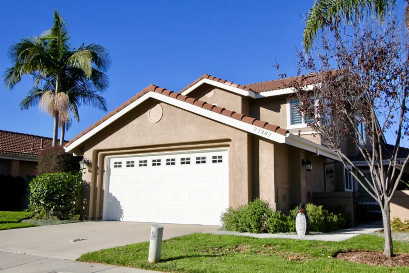 A sunny day in the area of Mesa Vista South, outside, garage, palm trees, grass, condo