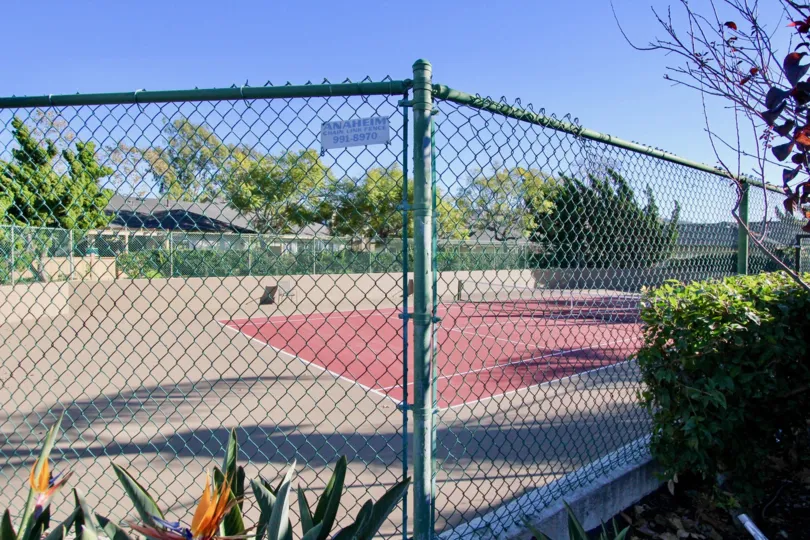 Fence surrounding a tennis court in Mission Point.