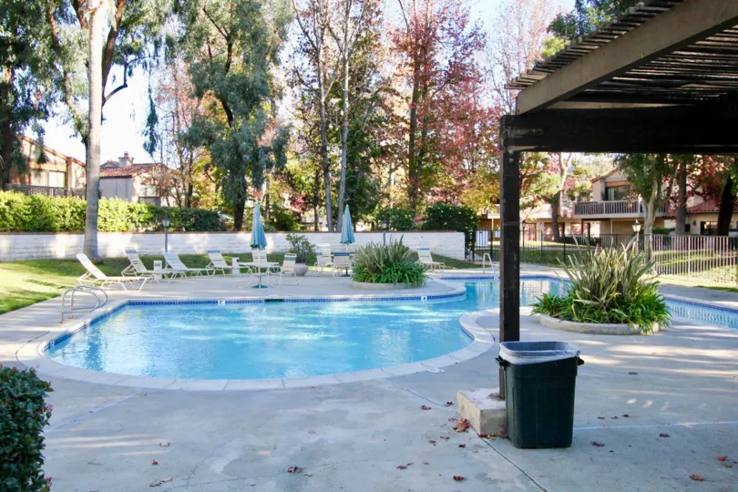 A brown wooden pergola sits above a patio at the Valle Pacifica community