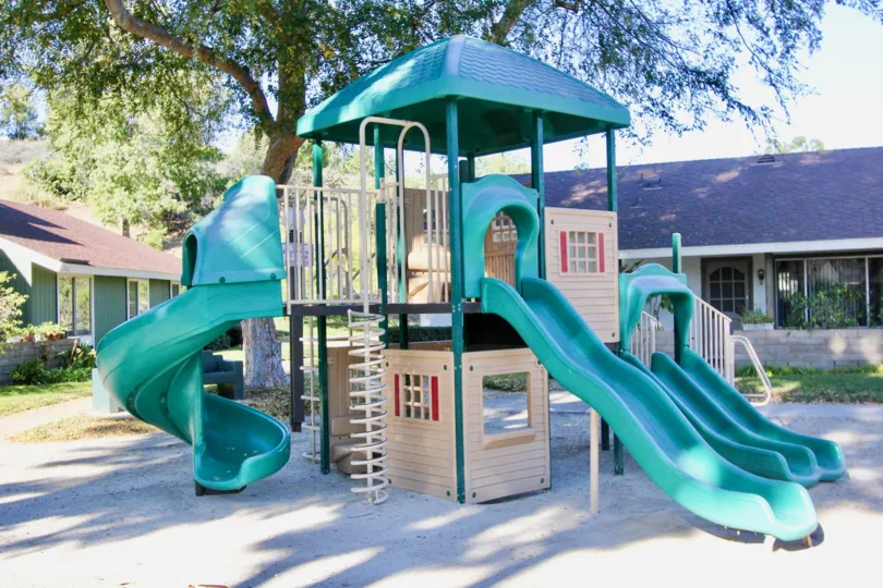 Gravel and playhouse at Village San Juan Townhomes in San Juan Capistrano, CA