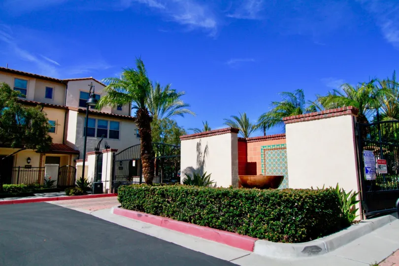 The gated entrance to the Avenue E community on a sunny day