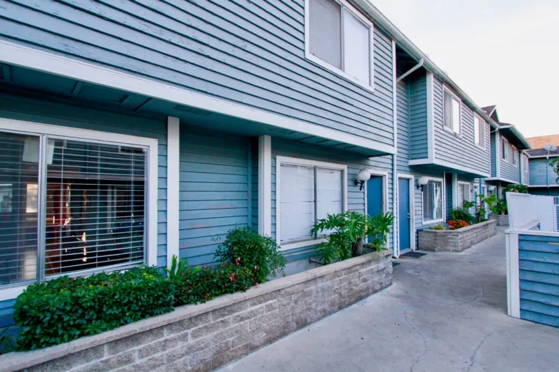 Friendly blue two story townhomes inside the Brightwood Square community in Santa Ana CA