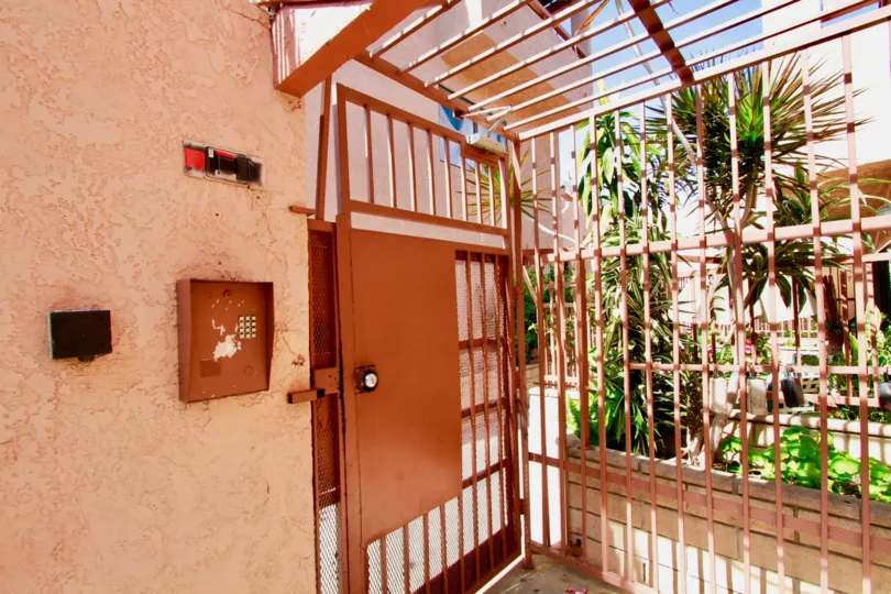 A metal gate to the Chestnut Manor community on a sunny day