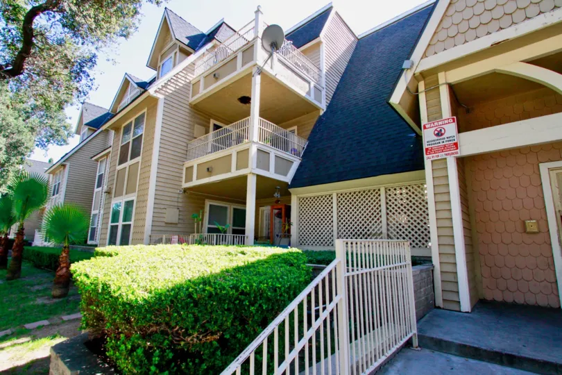 A large bunglow with blue sloped roofs and a large balcony in the Chestnut Square community