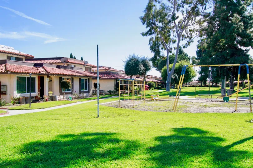 A sunny day in the Corsican Village with a park and buildings.