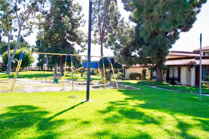 Playground outside beautiful home with trees in Corscican Village, Santa Ana CA