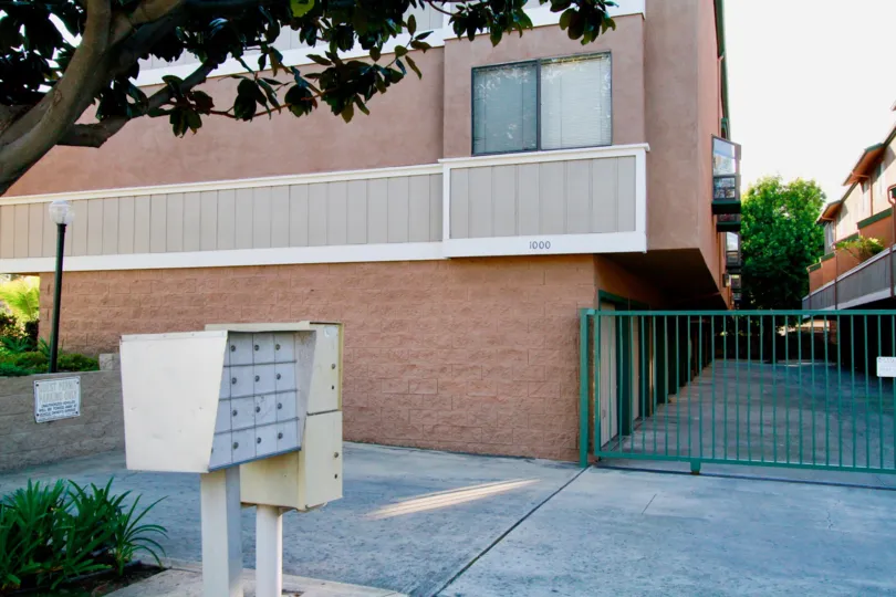 A red and white building with a green gate in Emerald Terrace.