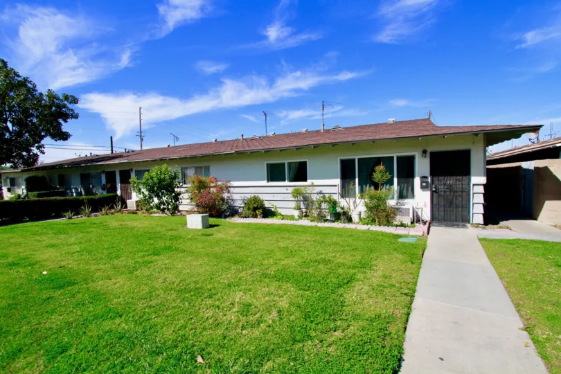 Outer View of a home in Garden Villas Community showing lawn and front view of Villa