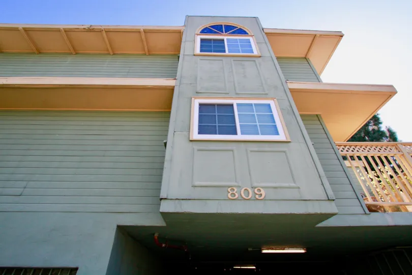 A close up view of building number 809 with a side balcony in the Heritage Park Place community