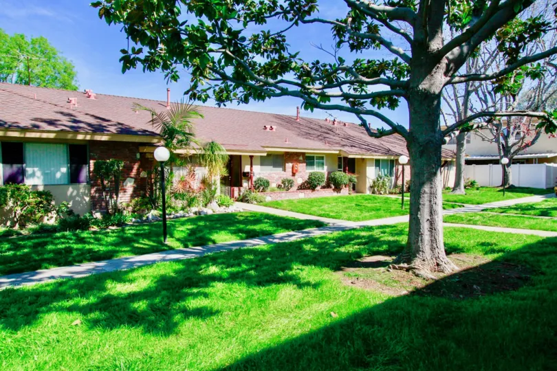 A view of the garden with green grass surrounding row houses in Hillview Regency community