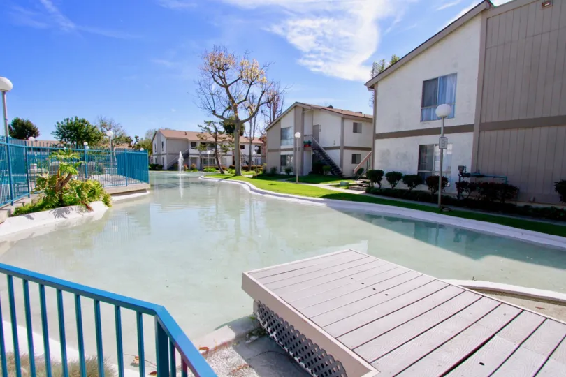 A lake in the Lakeshore community with a fountain on a sunny day.