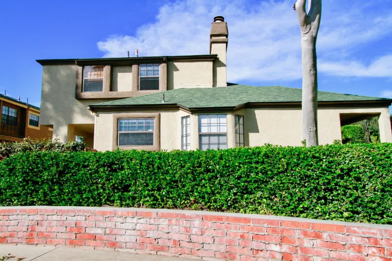 A lovely bunglow with a large garden in the front on a sunny day in Los Quatros Condos community